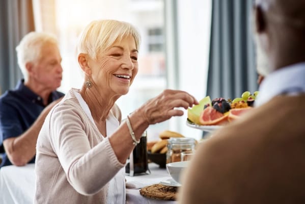 Resident enjoying a meal in a dining setting