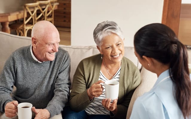 Residents enjoying coffee with a staff member