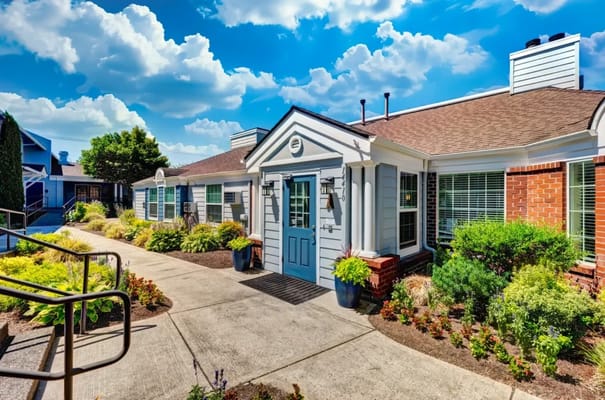 Exterior view of a senior living facility with landscaped walkway