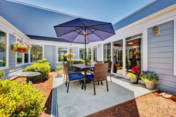 Outdoor seating area with flowers and an umbrella