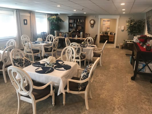 Dining area set up for residents with floral decor