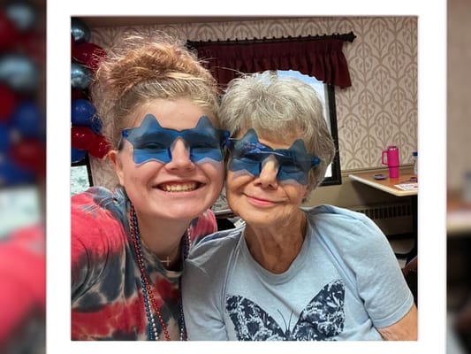 Residents enjoying a fun moment with themed glasses