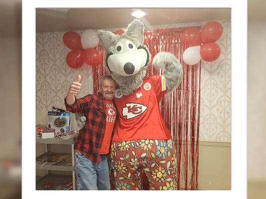 Resident enjoying a festive event with a mascot