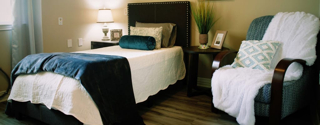 Cozy resident room with a bed and chair