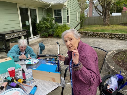Residents engaged in an outdoor art activity.
