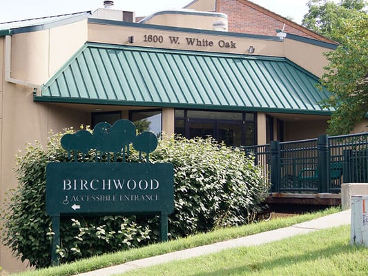 Exterior view of the Birchwood facility with accessible entrance sign