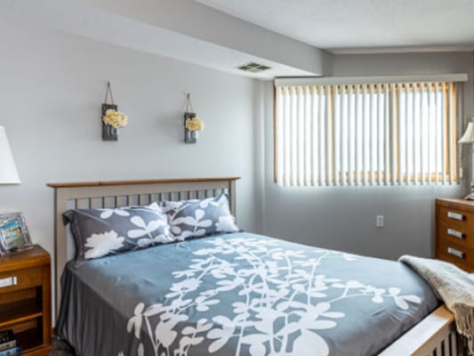 Cozy bedroom with floral decor and blinds