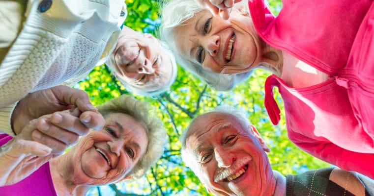 Seniors smiling and enjoying each other's company outdoors