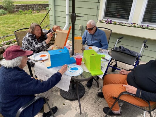 Residents participating in an outdoor art activity