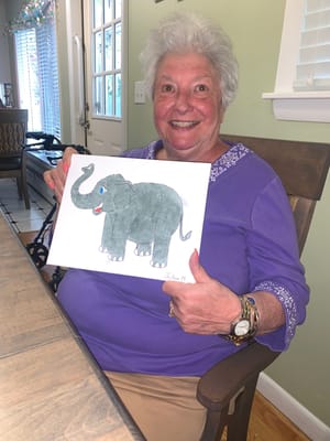 Resident proudly displaying her elephant drawing