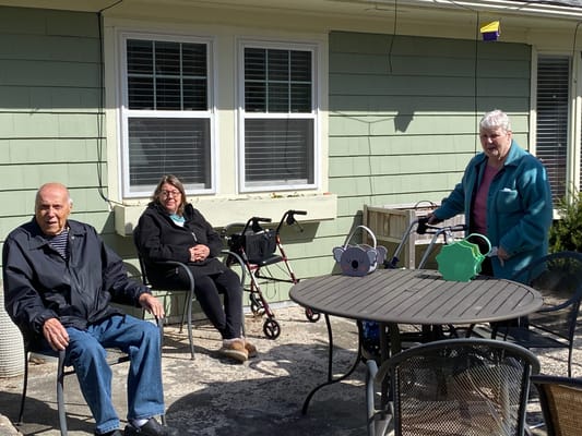 Residents enjoying time outside in a shaded area
