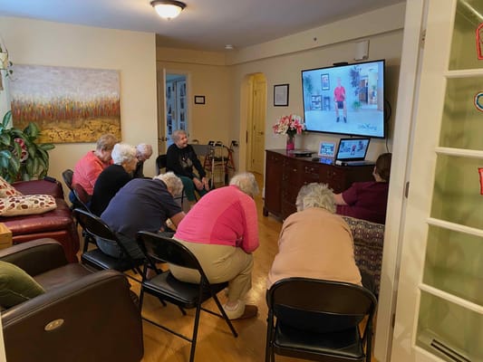Residents engaged in a group activity watching a video