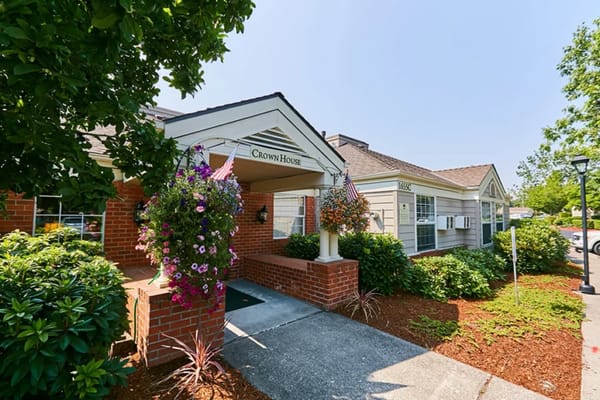 Front entrance of a senior living facility with flowers