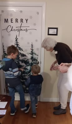 Resident interacting with children during Christmas celebration