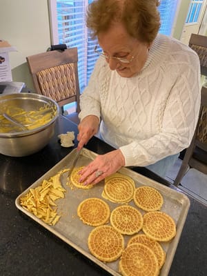 A resident preparing a meal in the kitchen
