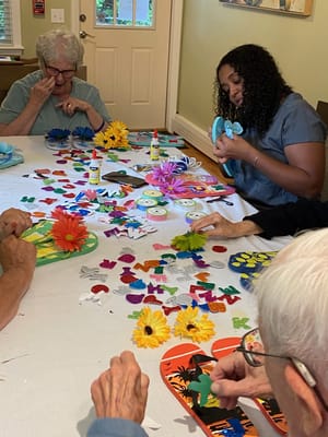 Residents engaged in a crafting activity at a table