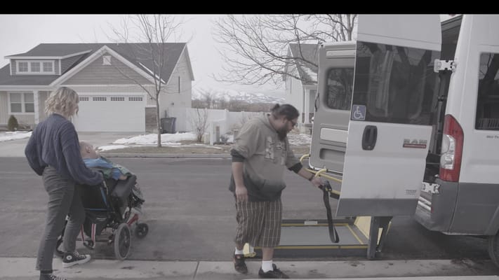 Accessible van with a resident being assisted.