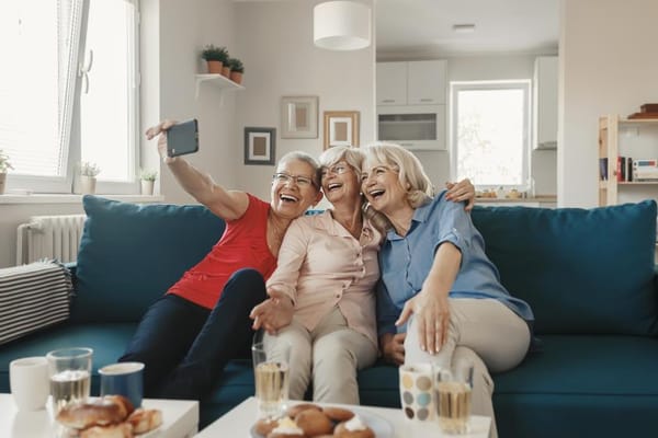 Three residents happily taking a selfie in a common area