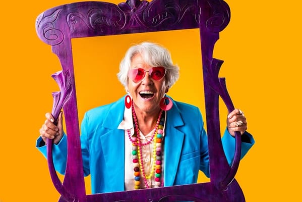 Elderly woman posing with a colorful frame