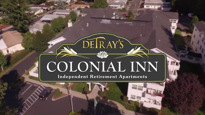 Aerial view of DeTray's Colonial Inn with logo