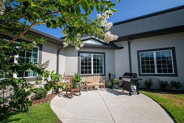 Outdoor seating area with grill and landscaping