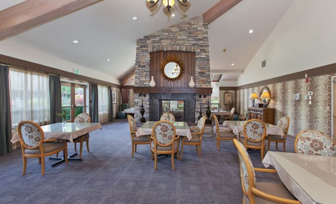 Interior view of a cozy common area with tables and chairs