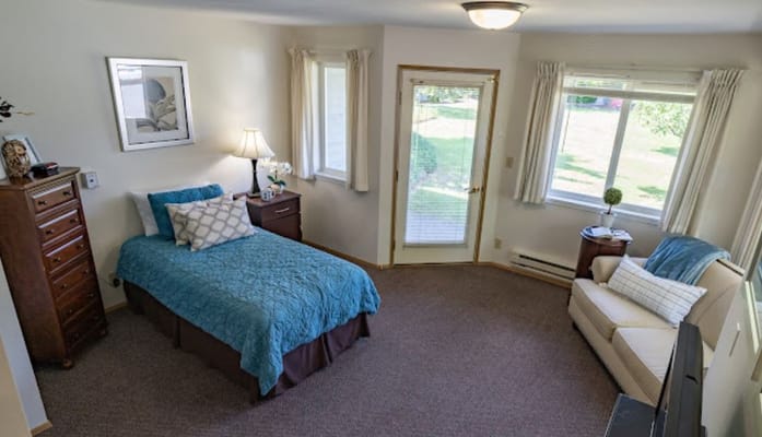 A bright resident room with a view and furnishings