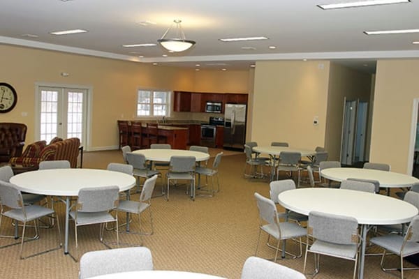 Bright common area with tables and chairs set up