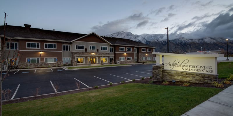 Exterior view of assisted living facility with mountains