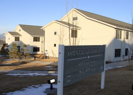 Building facade of Aspen Village Apartments with signage