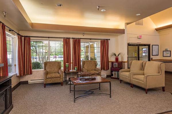 Bright common area with seating and large windows