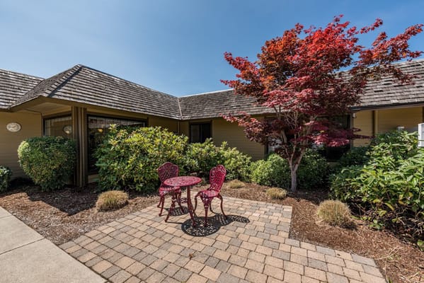 Outdoor seating area with a red table and chairs