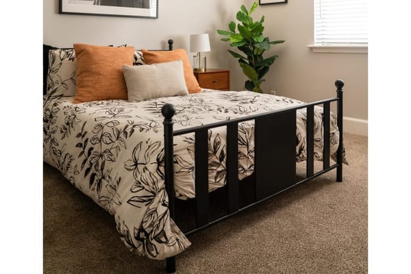 Cozy bedroom setup with floral bedding and decorative pillows