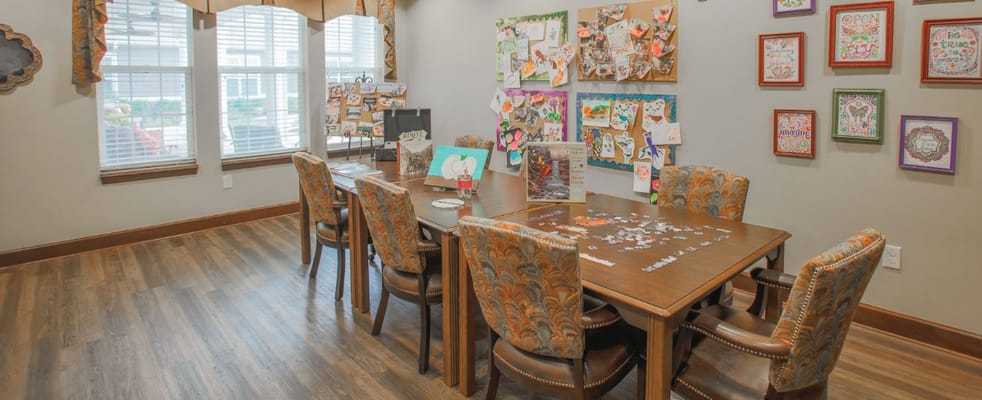 Bright activity room with tables and art displays