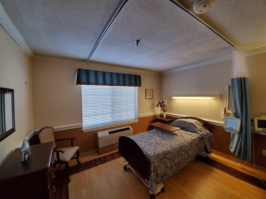 Cozy resident room with a bed and chair