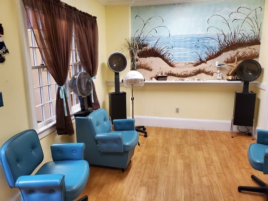 Interior of a salon area with beach mural