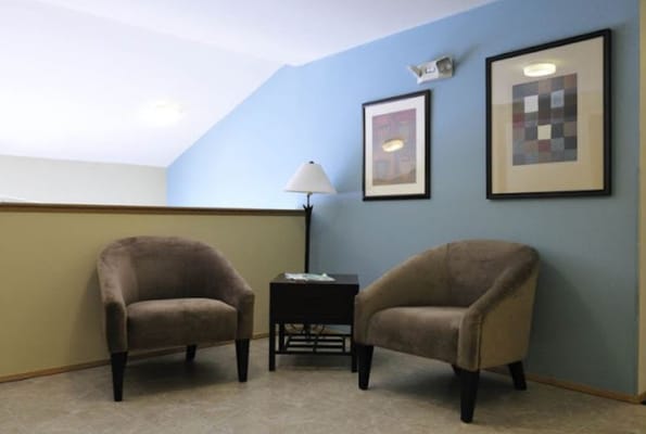 Cozy seating area with chairs and artwork