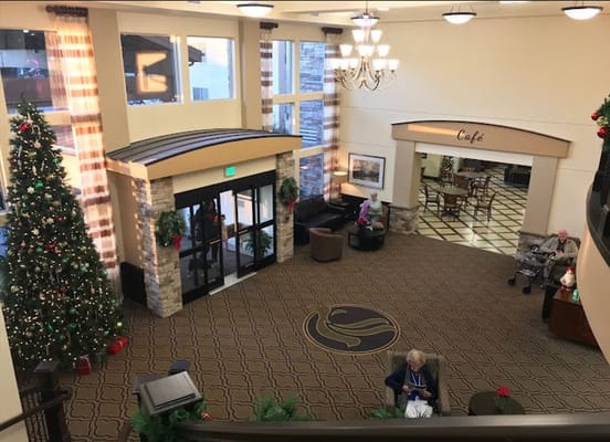 Interior view of a festive lobby with decorated Christmas tree