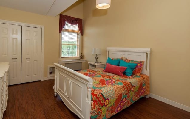 Brightly decorated resident room with colorful bedding