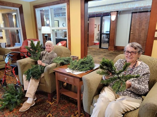 Residents decorating trees in a cozy common area