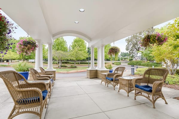 Outdoor seating area with flowers and greenery