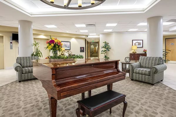 Interior lounge area with piano and chairs