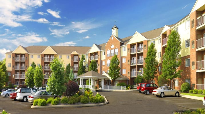 Exterior view of a senior living facility with landscaped areas