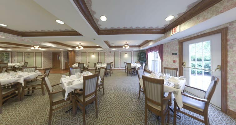 A dining room set up for meals in a senior living facility