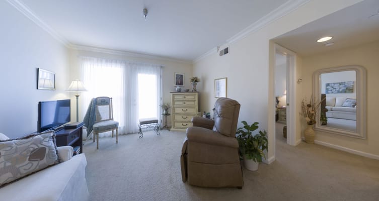 Cozy resident room with a recliner and natural light