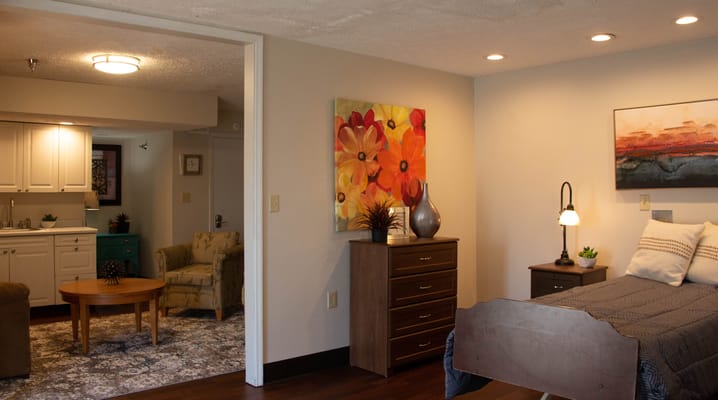 Bright, spacious resident room with floral artwork