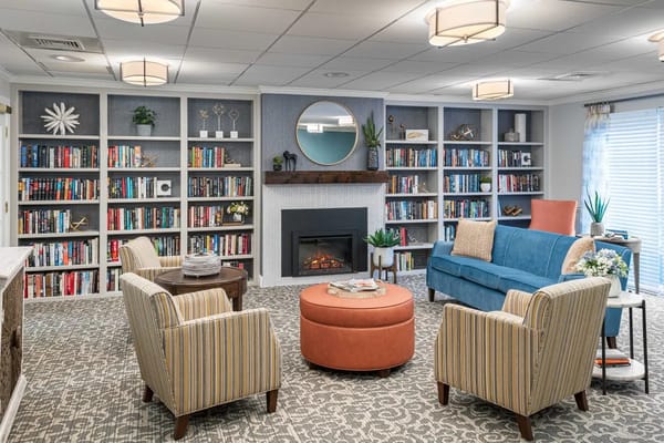 Cozy common area with bookshelves and comfortable seating