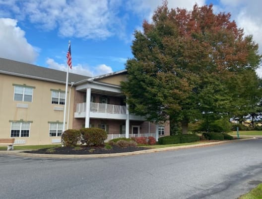 Exterior view of Complete Care at Lehigh Center with trees and sky