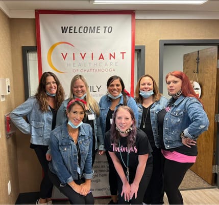 Staff posing together in the facility lobby