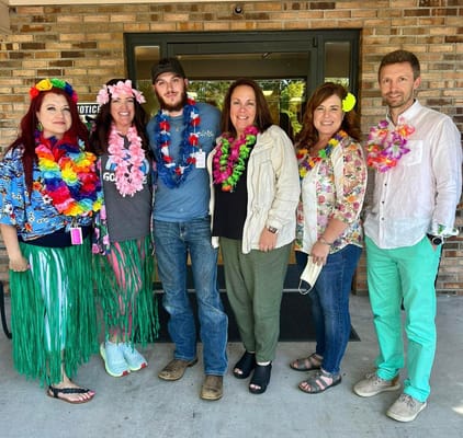 Staff and residents celebrating with leis and flowers
